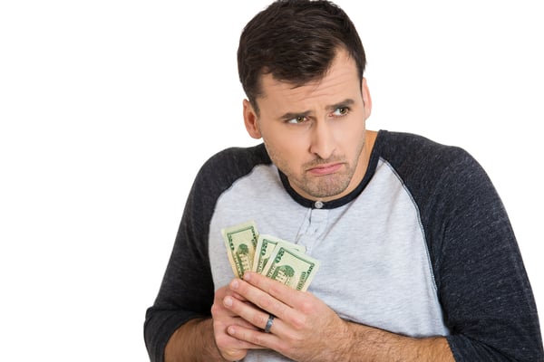 Closeup portrait of greedy man corporate employee, worker, student holding dollar banknotes tightly, isolated on white background. Negative human emotion facial expression feeling