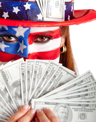 Rich American woman with the USA flag painted on her face holding dollars