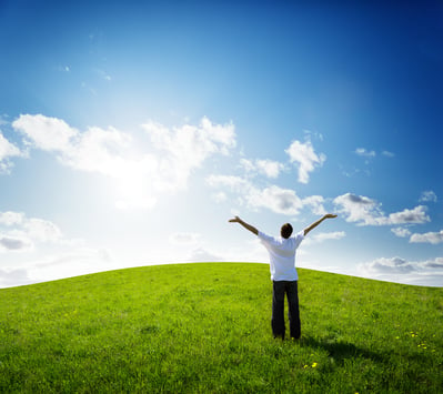 young man relax on the green field