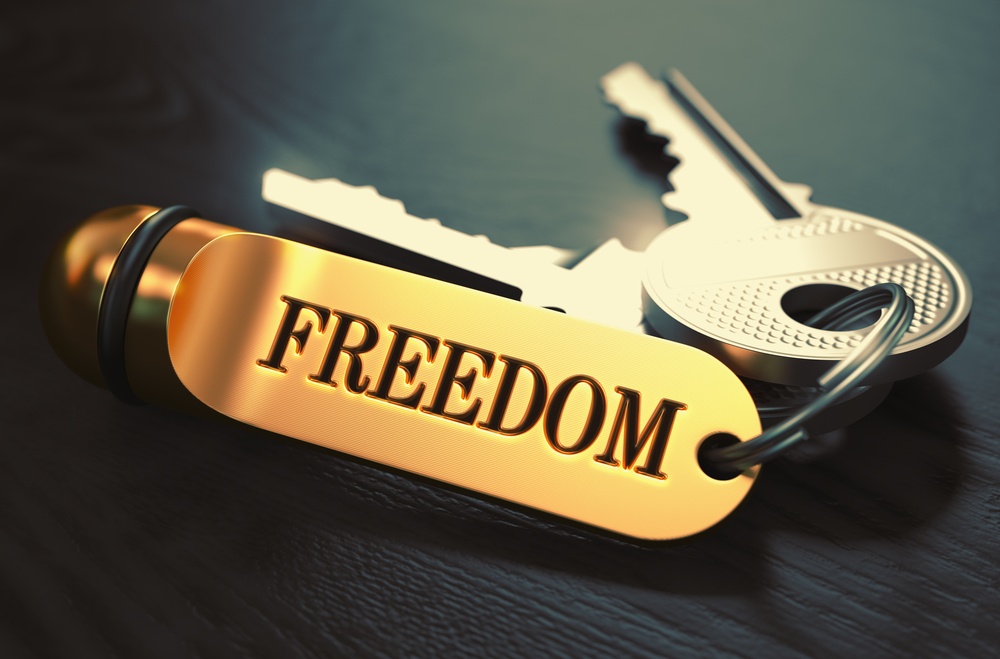 Keys to Freedom - Concept on Golden Keychain over Black Wooden Background. Closeup View, Selective Focus, 3D Render. Toned Image.